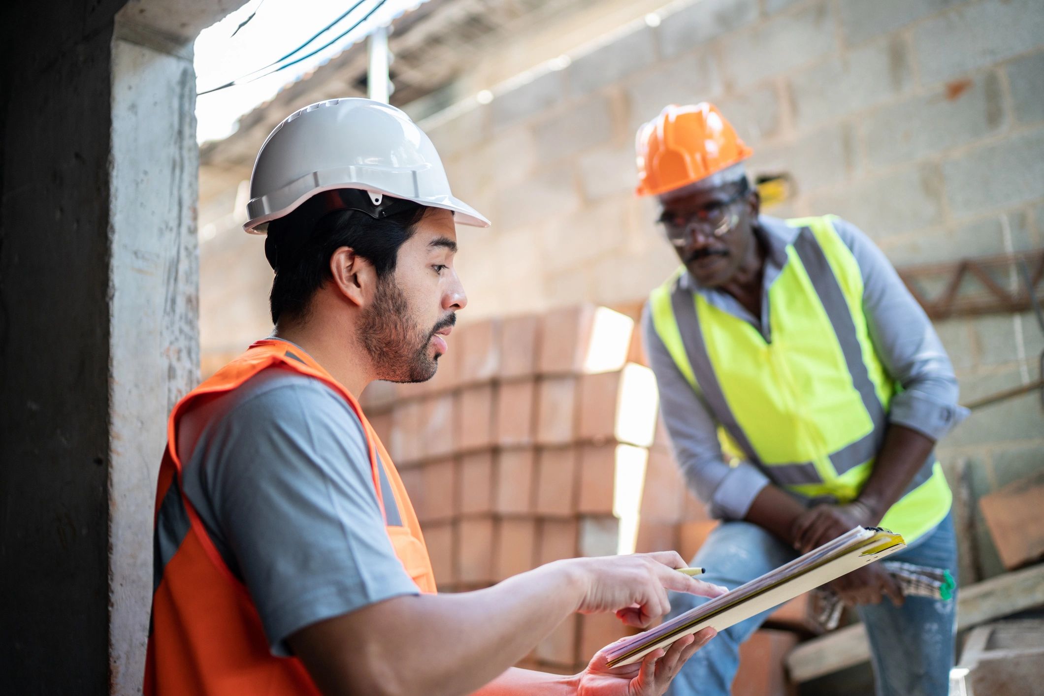Home service professionals in discussion at a job site