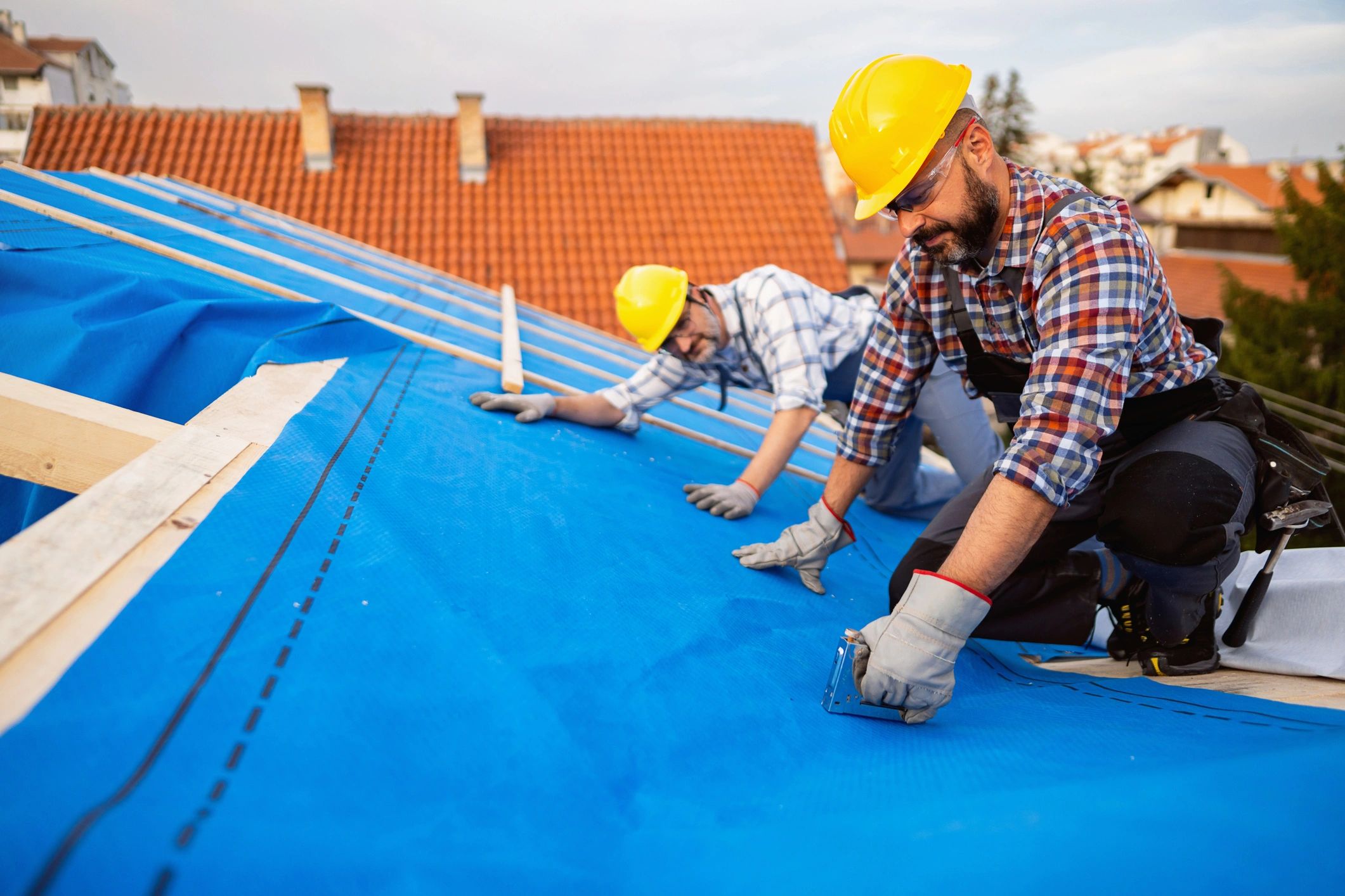 Roofing professionals working carefully on a roof